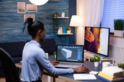 Rear view of businesswoman working at office