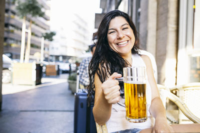 Portrait of a smiling young woman drinking drink