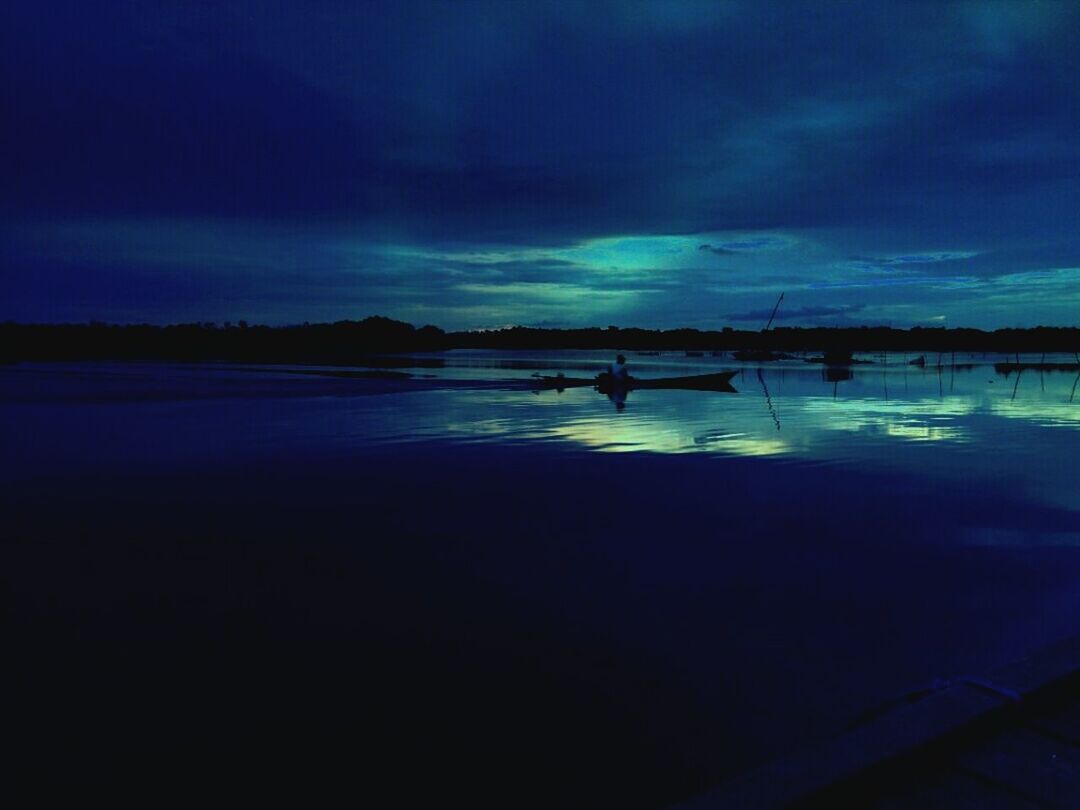 SILHOUETTE BIRDS FLYING OVER CALM LAKE