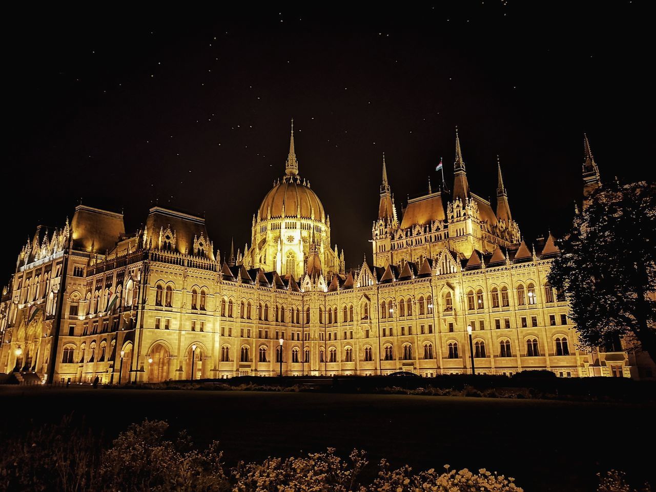 ILLUMINATED BUILDING AGAINST SKY AT NIGHT