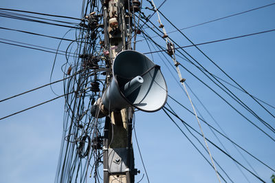 Low angle view of electricity pylon against sky
