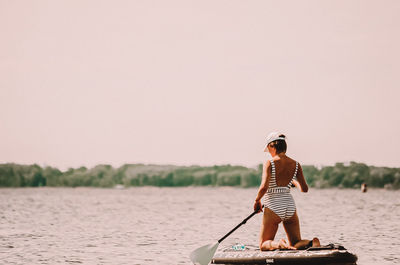 Sportgirl on the sap board swim on the river