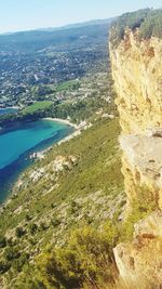 Aerial view of sea and cityscape against sky