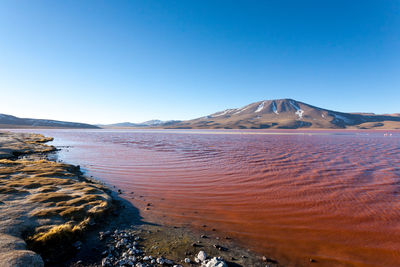 Scenic view of mountains against clear blue sky