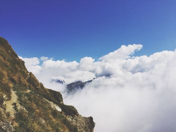 Low angle view of mountain against cloudy sky