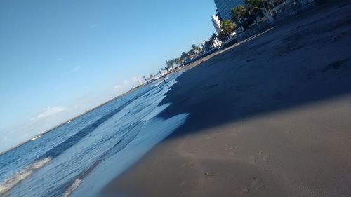 View of calm beach against blue sky