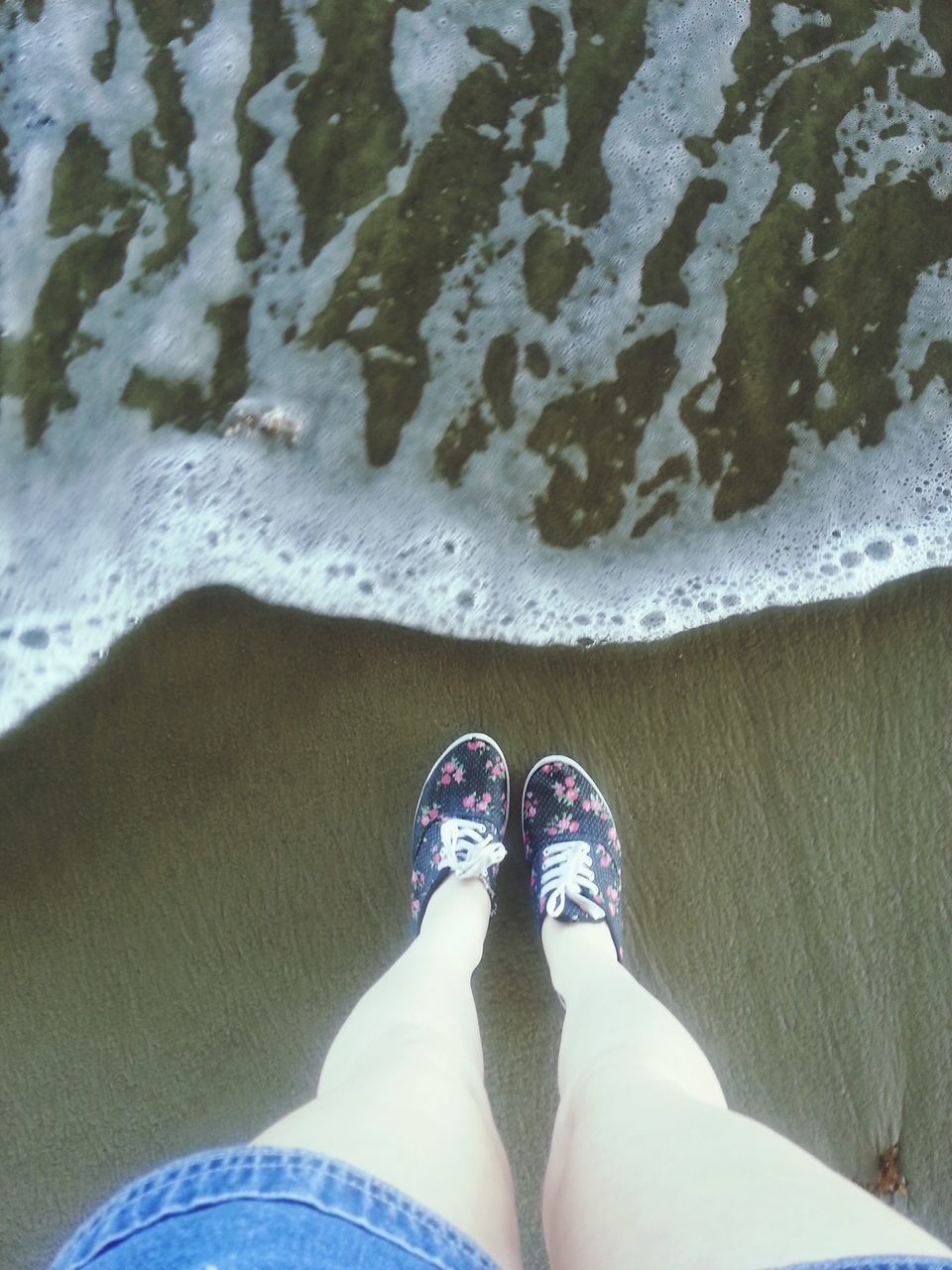 low section, person, personal perspective, shoe, human foot, standing, lifestyles, footwear, leisure activity, high angle view, men, jeans, water, unrecognizable person, beach, sand, barefoot