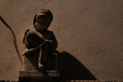 Low angle view of statue against wall