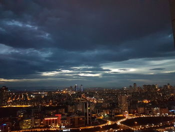 Illuminated cityscape against sky at night