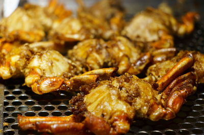 Close-up of meat on metal grate