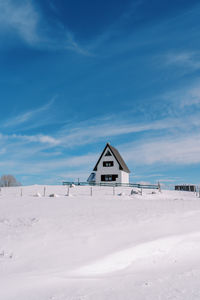 House on snow covered landscape