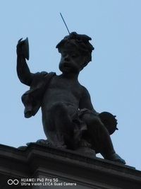 Low angle view of statue against sky