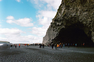 People walking on road against sky