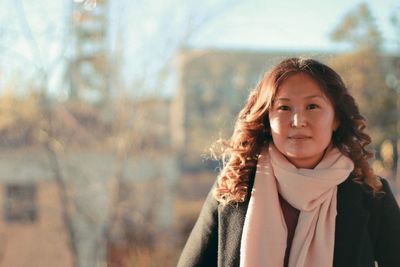 Portrait of young woman standing outdoors