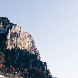 Low angle view of rocks against clear sky