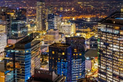 High angle view of illuminated buildings in city at night