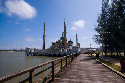 View of mosque and buildings against sky