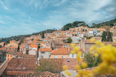 Buildings in town against sky