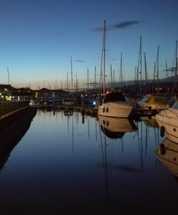 Boats moored at harbor