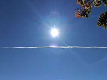 The sun looks like the pupil of a blue eye above a thin white line