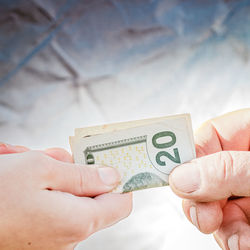 Cropped hand of woman holding paper currency