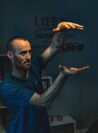 Close-up of man standing against wall