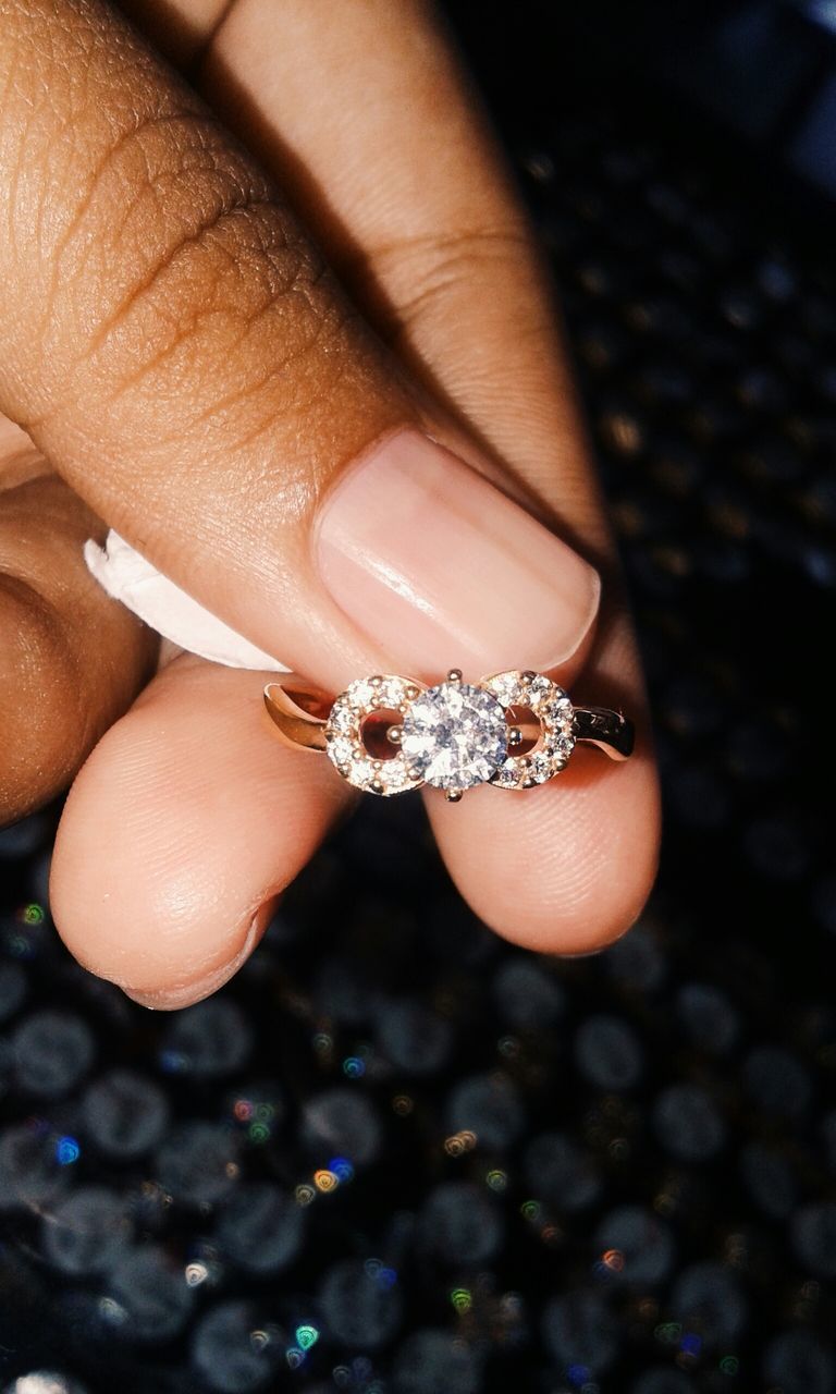 person, part of, close-up, human finger, holding, cropped, jewelry, unrecognizable person, focus on foreground, indoors, ring, palm, high angle view, showing, selective focus, personal perspective