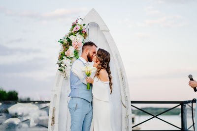 Couple holding bouquet of flowers