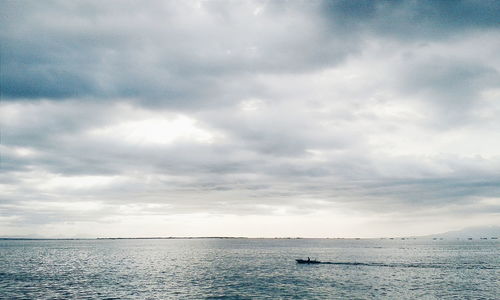 Scenic view of sea against cloudy sky