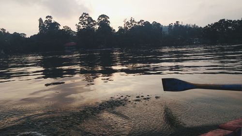 Scenic view of lake against sky at sunset