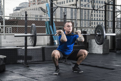 Man training at rooftop gym in bangkok