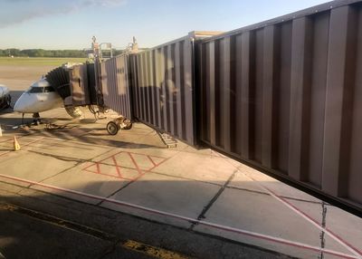 Train on airport runway against sky