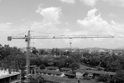 Construction site by buildings against sky