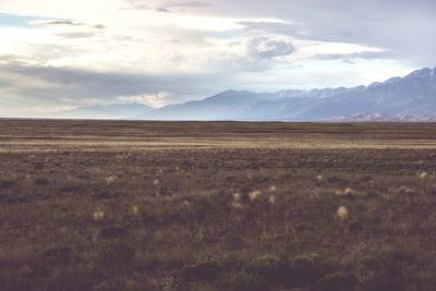 Scenic view of landscape against cloudy sky