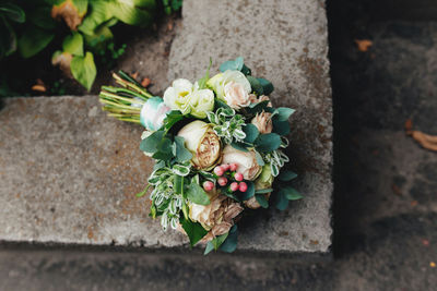 Wedding bouquet on the concrete or stone fence