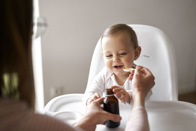 Mother feeding baby at home