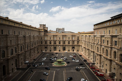 Vehicles on road along buildings