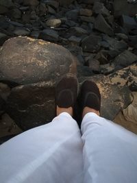 Low section of woman standing on cobblestone