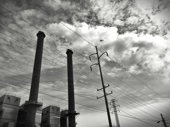 Low angle view of power lines against cloudy sky