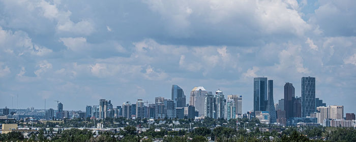 Panoramic view of buildings in city against sky