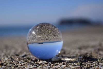 Close-up sea reflecting on circular ball