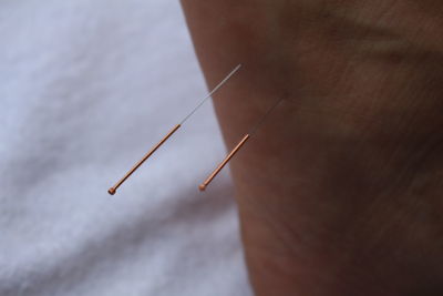 Close-up of needle on hand