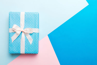 High angle view of gift box on blue background