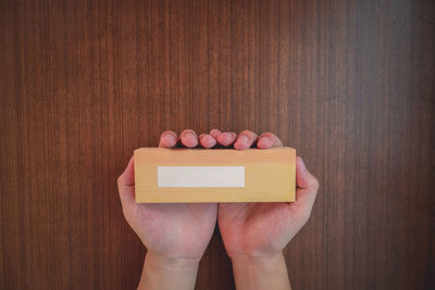 Close-up of hand holding paper