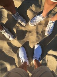 Low section of people standing on beach