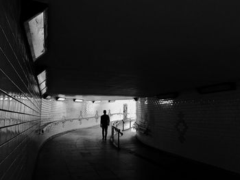 People on illuminated walkway