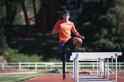 Man with prostethic leg jumping