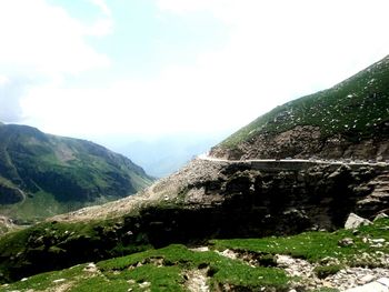 Scenic view of mountains against cloudy sky