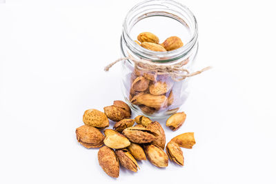 High angle view of bread in jar on white background