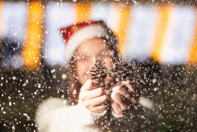 Portrait of man holding glass window during rainy season